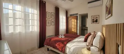 a bedroom with a bed and a large window at Villa Olimp in Super Cannes with sea view in Le Cannet