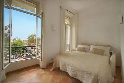 a bedroom with a bed and a large window at Elégant 2 pièces vue MER, FELIX FAURE- COEUR DE CANNES A1B271 in Cannes