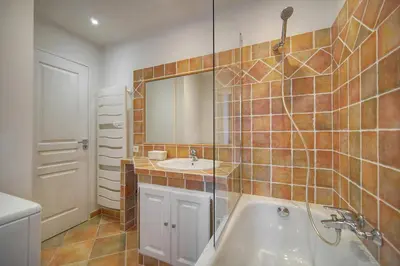a bathroom with a tub and a sink and a mirror at Elégant 2 pièces vue MER, FELIX FAURE- COEUR DE CANNES A1B271 in Cannes