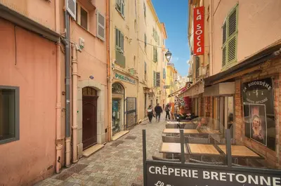 a narrow street with people walking down the street at Elégant 2 pièces vue MER, FELIX FAURE- COEUR DE CANNES A1B271 in Cannes