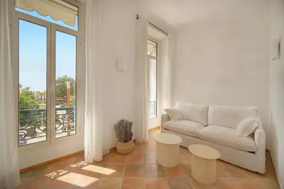 a living room with a couch and two tables at Elégant 2 pièces vue MER, FELIX FAURE- COEUR DE CANNES A1B271 in Cannes