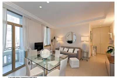a living room with a glass table and a couch at REF 961 - Cannes Croisette - Sea view apartment for rent in Cannes