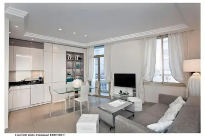 a living room with a couch and a table at REF 961 - Cannes Croisette - Sea view apartment for rent in Cannes