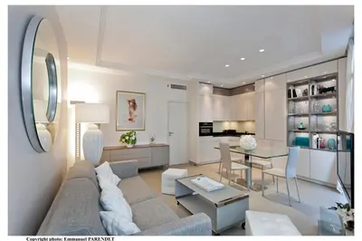 a living room with a couch and a table at REF 961 - Cannes Croisette - Sea view apartment for rent in Cannes