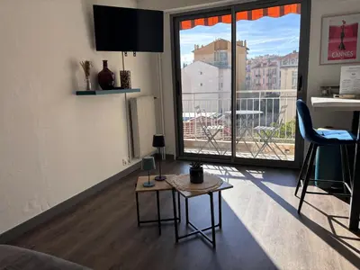 a living room with a couch and a table at Studio rénové marche Forville Cannes in Cannes