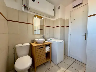 a small bathroom with a toilet and a sink at Cannes Eden By SCLS Locations in Cannes