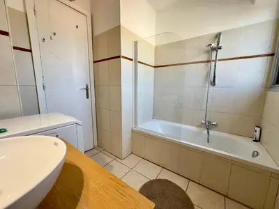 a bathroom with a tub and a toilet and a sink at Cannes Eden By SCLS Locations in Cannes