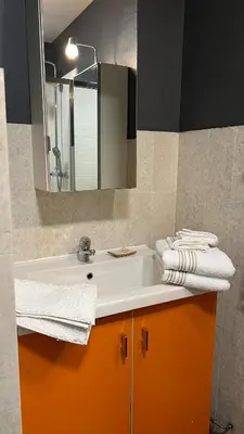 a bathroom with a sink and a mirror and towels at Studio cosy Cannes centre in Cannes