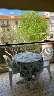 a table and two chairs on a balcony at Studio cosy Cannes centre in Cannes