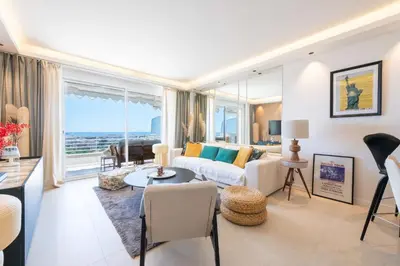 a living room with a couch and a table at 2-Br Apartment with Sea View Terrace Cannes in Cannes