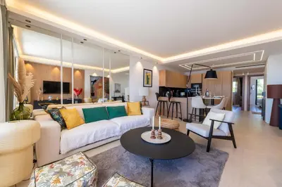 a living room with a couch and a table at 2-Br Apartment with Sea View Terrace Cannes in Cannes