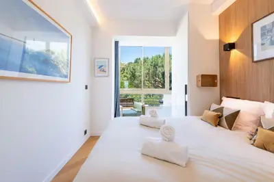 a bedroom with a large white bed with towels on it at 2-Br Apartment with Sea View Terrace Cannes in Cannes