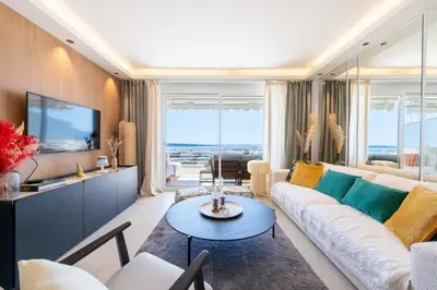 a living room with a couch and a tv at 2-Br Apartment with Sea View Terrace Cannes in Cannes