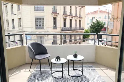 a balcony with two chairs and two tables on a balcony at Paradisio in Cannes
