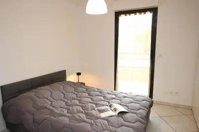 a bedroom with a bed with two books on it at Paradisio in Cannes
