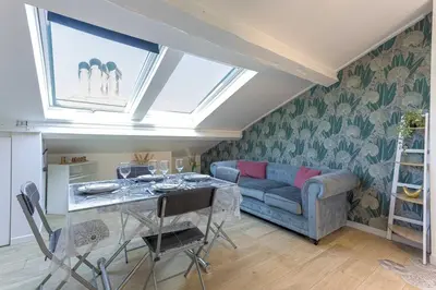 a living room with a blue couch and a table at Bulle d'Azur - 10mn from Palais&Beaches, air conditioning, center in Cannes