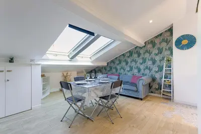 a dining room with a table with chairs and a window at Bulle d'Azur - 10mn from Palais&Beaches, air conditioning, center in Cannes