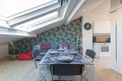 a living room with a table and a couch at Bulle d'Azur - 10mn from Palais&Beaches, air conditioning, center in Cannes