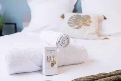 a pile of towels sitting on top of a bed at Bulle d'Azur - 10mn from Palais&Beaches, air conditioning, center in Cannes