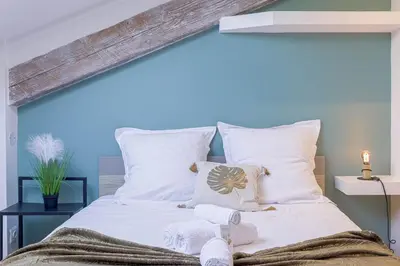 a bedroom with a bed with towels on it at Bulle d'Azur - 10mn from Palais&Beaches, air conditioning, center in Cannes