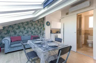 a living room with a table and a couch at Bulle d'Azur - 10mn from Palais&Beaches, air conditioning, center in Cannes