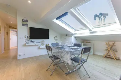 a dining room with a table with chairs and a tv at Bulle d'Azur - 10mn from Palais&Beaches, air conditioning, center in Cannes