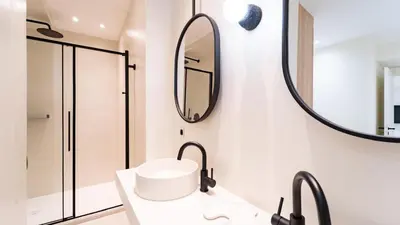 a bathroom with two sinks and a mirror at 3BDR Cocoon in Cannes Martinez avec Jardin Privé & Design Contemporain à 5 min de la Croisette in Cannes