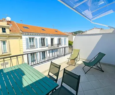 a patio with a green table and chairs on a balcony at Stylish Cannes Gem, Terrace, Parking, 100m to Croisette in Cannes