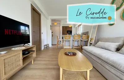 a living room with a couch and a table at Le Cirodde By SCLS Locations in Cannes