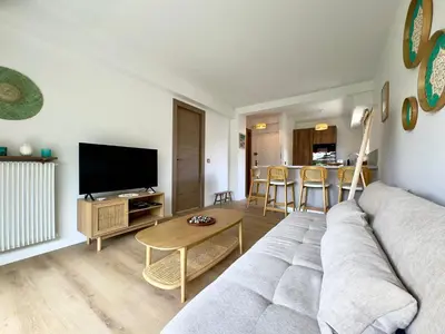 a living room with a couch and a table at Le Cirodde By SCLS Locations in Cannes
