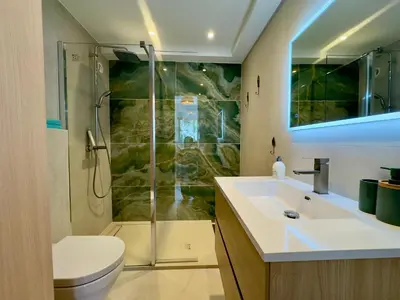 a bathroom with a shower and a sink and a toilet at Le Cirodde By SCLS Locations in Cannes