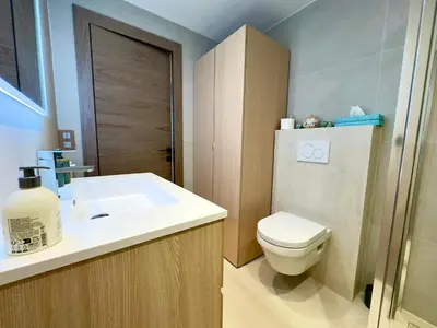 a bathroom with a toilet and a sink at Le Cirodde By SCLS Locations in Cannes