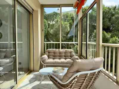a screened in porch with a table and chairs at Le Cirodde By SCLS Locations in Cannes
