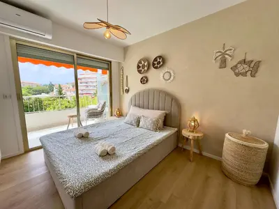 a bedroom with a large bed and a large window at Le Cirodde By SCLS Locations in Cannes