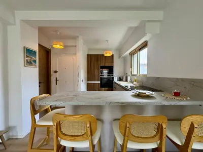 a kitchen with a large marble table and chairs at Le Cirodde By SCLS Locations in Cannes