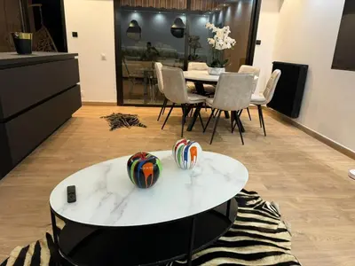 a living room with a table and chairs at apartment in Cannes-Croisette in Cannes