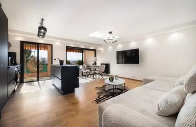 a living room with a couch and a table at apartment in Cannes-Croisette in Cannes