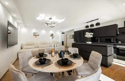 a dining room and kitchen with a table and chairs at apartment in Cannes-Croisette in Cannes