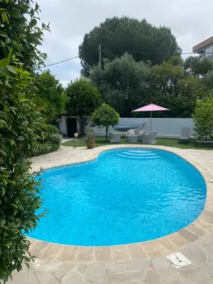 a large blue swimming pool in a yard at Bastide Anna in Le Cannet