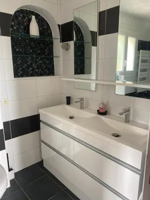 a bathroom with two sinks and a mirror at Bastide Anna in Le Cannet