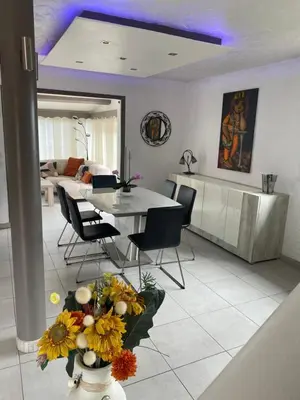 a kitchen and dining room with a table and chairs at Bastide Anna in Le Cannet