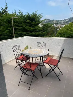 a table and four chairs sitting on a patio at Bastide Anna in Le Cannet