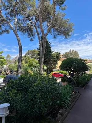 a park with trees and plants and a red car at Le Cannet Rocheville grand 3 pieces 2 terrasses in Le Cannet