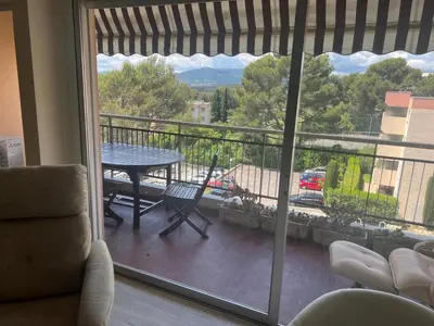 a room with a view of a balcony with a table at Le Cannet Rocheville grand 3 pieces 2 terrasses in Le Cannet