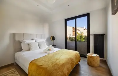 a bedroom with a large bed and a large window at Prestigious apartment in Cannes in Cannes