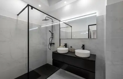a bathroom with two sinks and a glass shower at Prestigious apartment in Cannes in Cannes