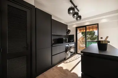 a kitchen with black cabinets and a black counter at Prestigious apartment in Cannes in Cannes