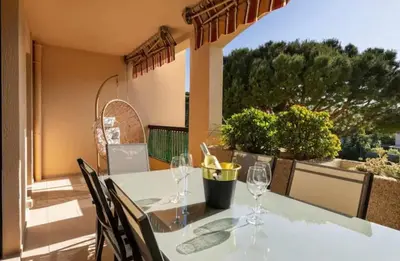 a table with wine glasses on a balcony at Prestigious apartment in Cannes in Cannes