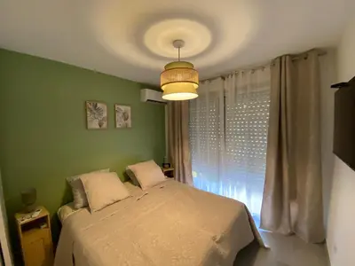 a bedroom with a bed and a ceiling at Les Jades in Le Cannet