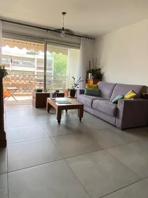 a living room with a couch and a coffee table at Les Jades in Le Cannet